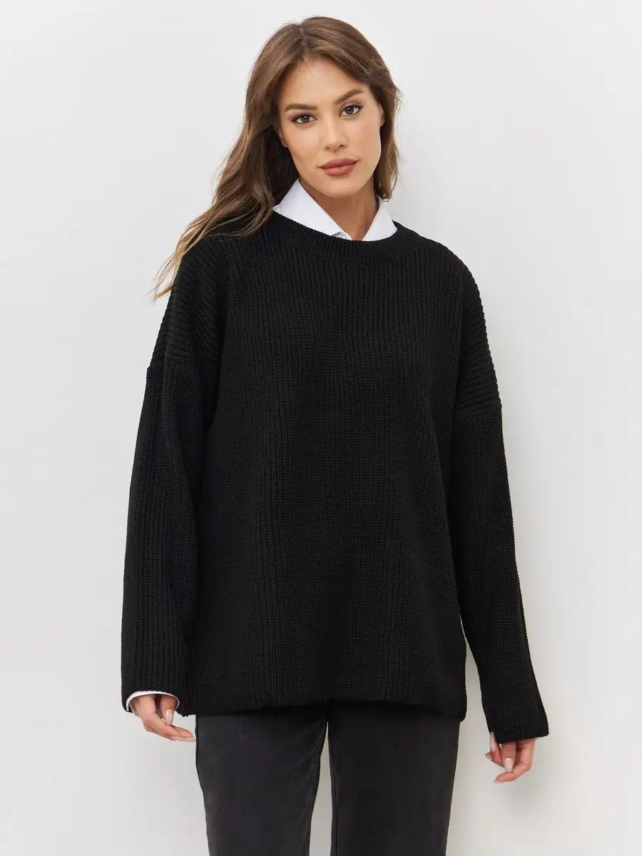 Portrait shot of woman in black knit sweater over white collar shirt against white background