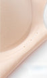 Detailed close-up of a beige seamless bra’s raised side support.