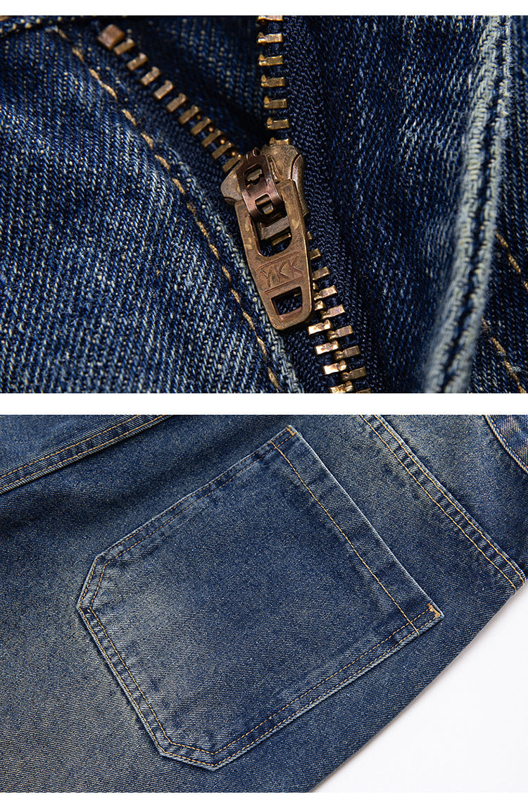 Close-up detail of medium wash denim jeans waistband showing metal button closure and belt loop construction with contrast stitching