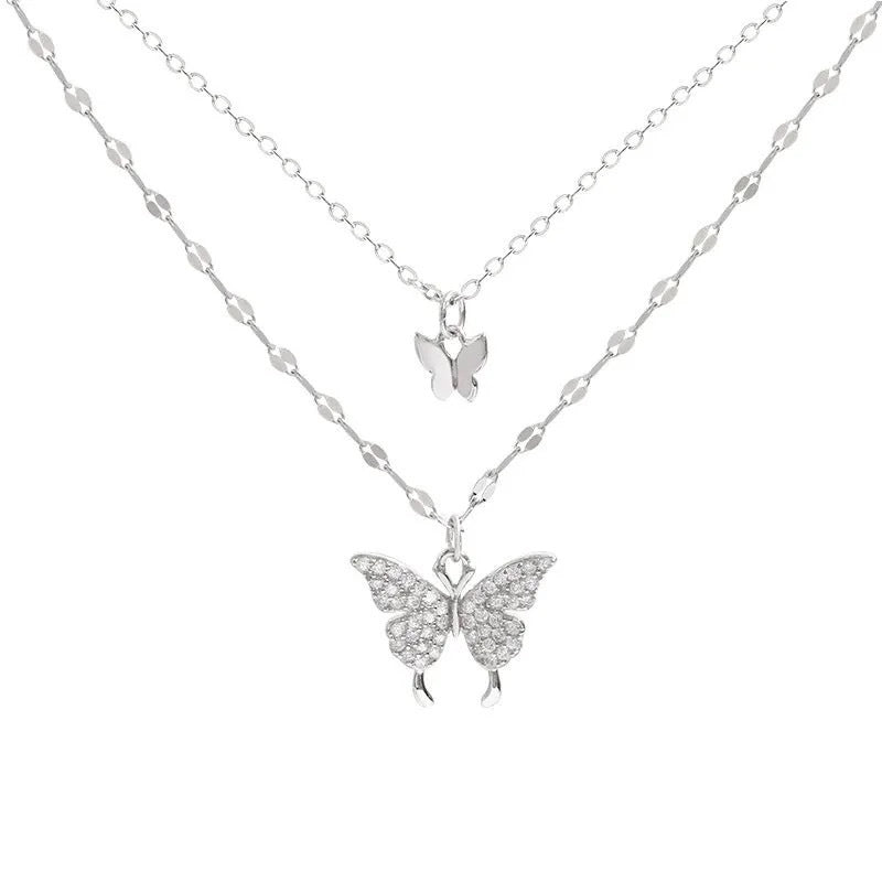 Product photo of silver layered necklace featuring small and crystal-detailed butterfly pendants