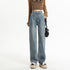 Light-wash wide-leg denim jeans with cropped brown sweater and neutral sneakers, showcasing street-style casual fashion