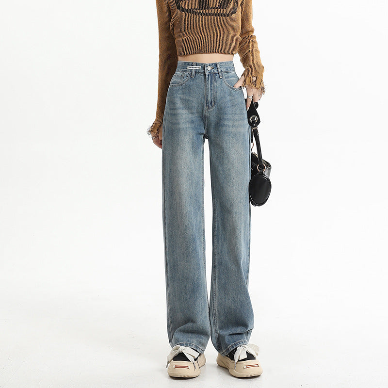 Light-wash wide-leg denim jeans with cropped brown sweater and neutral sneakers, showcasing street-style casual fashion
