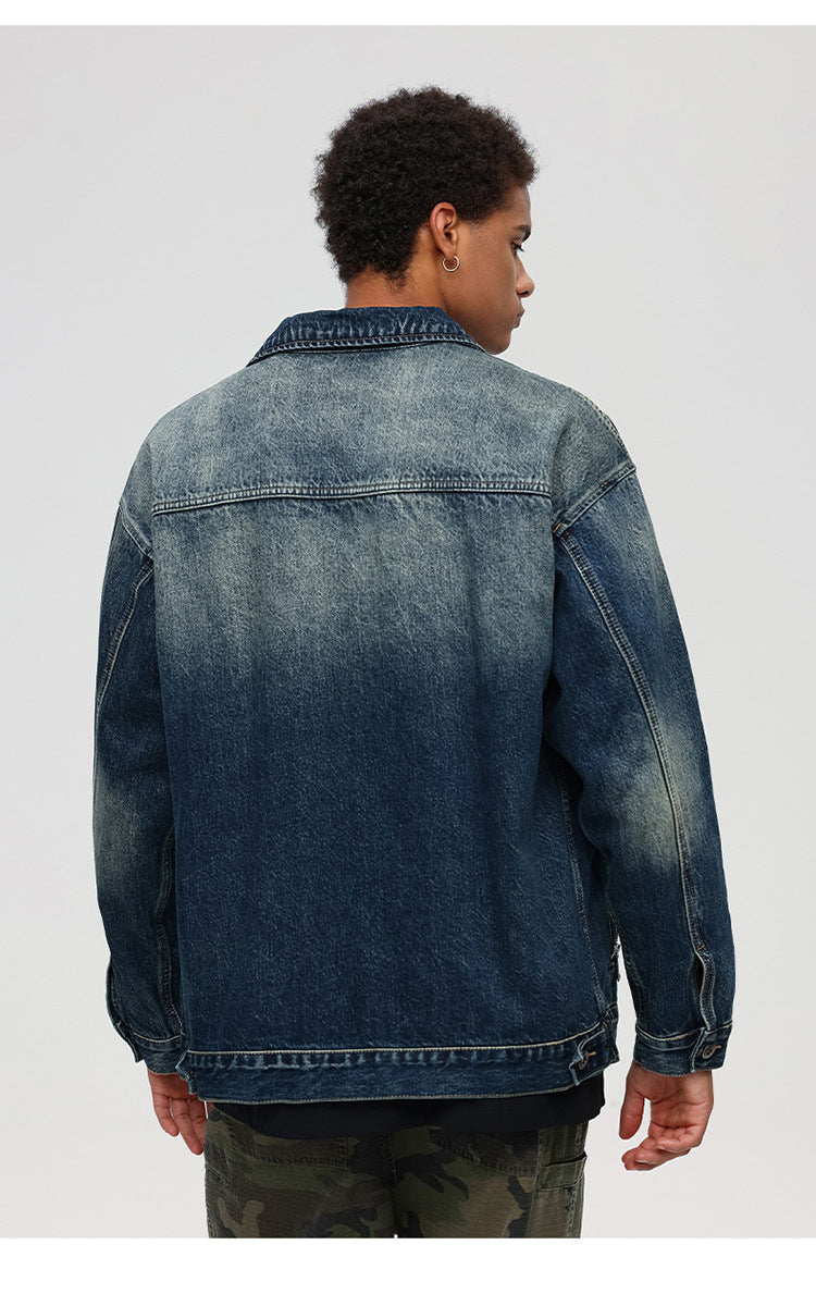 Back view of male model showing denim jacket's faded wash detail