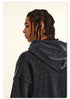 Rear view of model in black hoodie with braided hair, showing NE2C logo