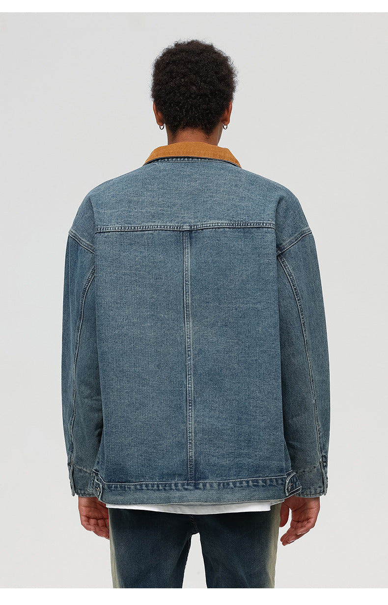 Back view of denim jacket showing center seam detail and brown corduroy collar against white background