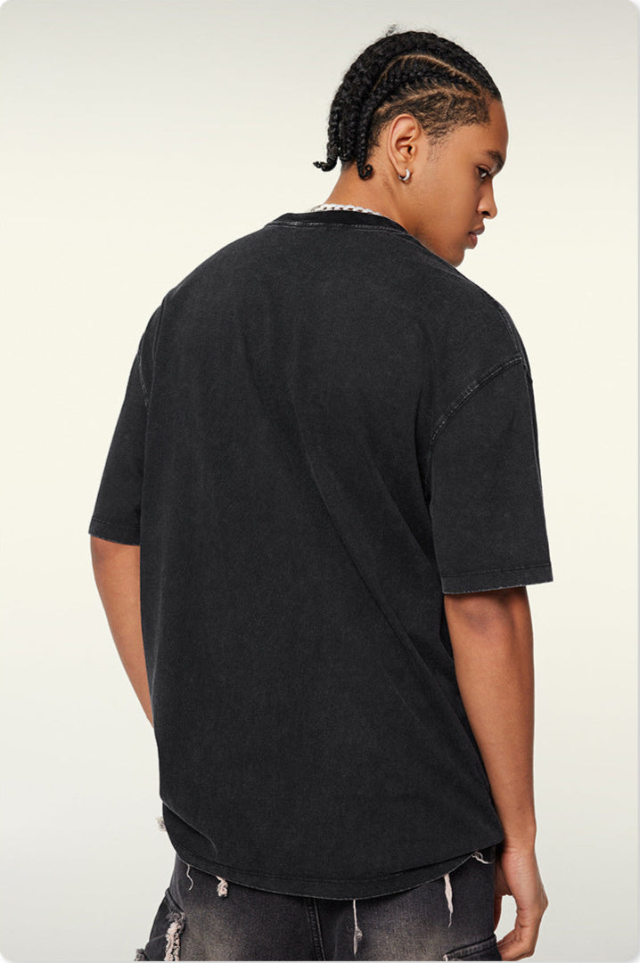 Back view of black oversized t-shirt showing clean construction and detailed stitching