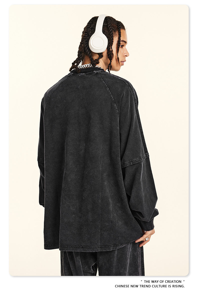 Profile view of model wearing black sweatshirt and white headphones