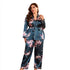 Dark blue-green satin pajama set with floral print, including a wrap-style top with tie waist and matching wide-leg pants