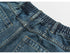 Front view of balloon-fit medium-wash jeans with vertical seams and split hem detail