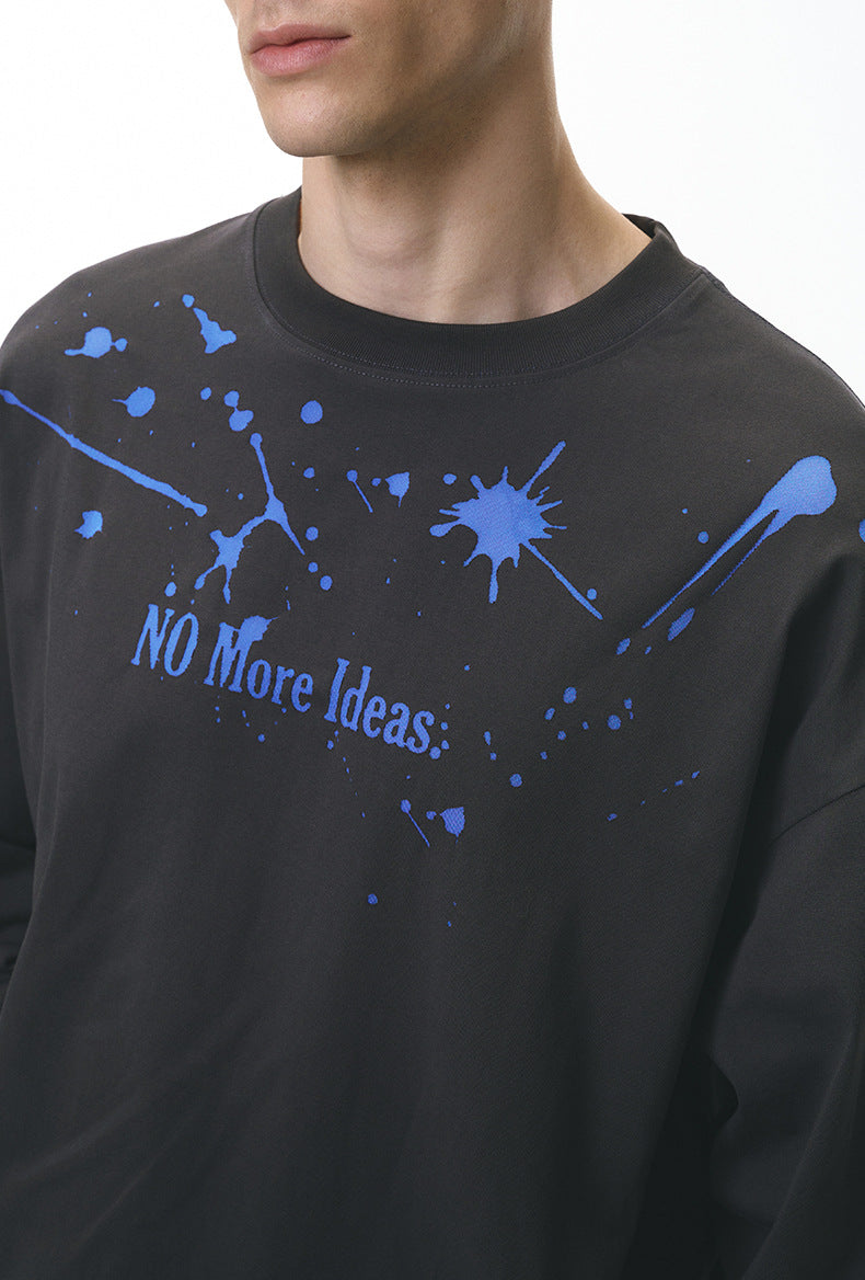 Close-up of gray "NO More Ideas" graphic print on long sleeve t-shirt