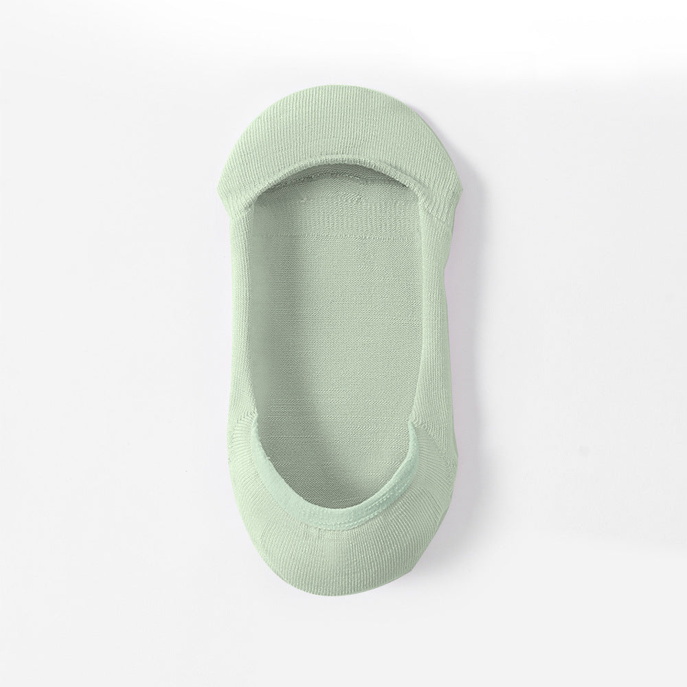 Green no-show sock liner photographed at angle, showing inner sole texture