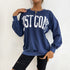 Navy blue East Coast sweatshirt styled with ripped black shorts and gold chain necklace