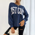 Front view of East Coast sweatshirt with white handbag accessory styling