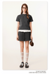 Dark grey t-shirt with white ruffle hem detail, paired with drawstring mini skirt, styled with cropped fit