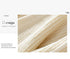 Close-up texture detail of cream colored chunky knit fabric with ribbed pattern