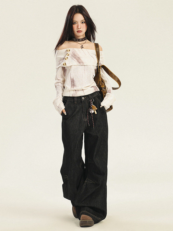 A model is standing with off-white bardot top, ultra-wide black denim jeans, black leather choker with cross pendant, and brown canvas bag