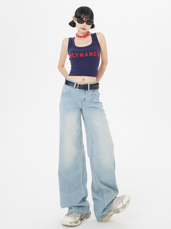 Model wearing navy MLYNARCIN crop tank, light wash wide-leg jeans, white sneakers, and sunglasses against white backdrop