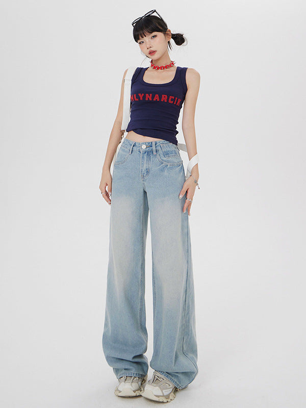 Full-length shot of model in MLYNARCIN navy tank top and extra-wide light wash denim jeans on white background