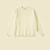 Cream colored crewneck sweatshirt with ribbed collar and cuffs on soft beige background