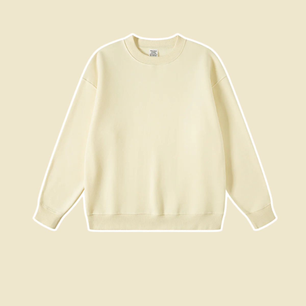 Cream colored crewneck sweatshirt with ribbed collar and cuffs on soft beige background