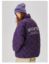 Back view of woman wearing purple Aesthetic puffer jacket featuring brand text logo, styled with purple knit beanie and khaki pants