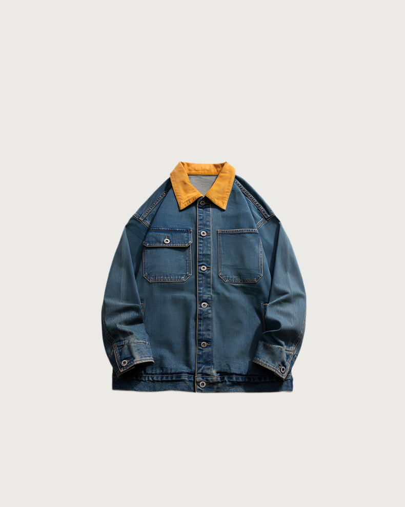 Flat lay of oversized denim shirt jacket with brown corduroy collar and chest pockets against light background