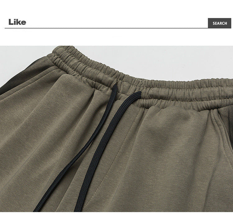 Close-up of gray wide-leg pants waistband showing the elastic band and black drawstring