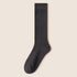 Single dark gray knee-high sock displayed flat against cream background