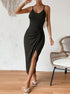 Woman posing in black ribbed knit midi dress with thigh-high slit and bodycon fit.
