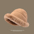 Camel bucket hat with matching faux fur trim, side view showing plush texture, UV protection design, neutral taupe background