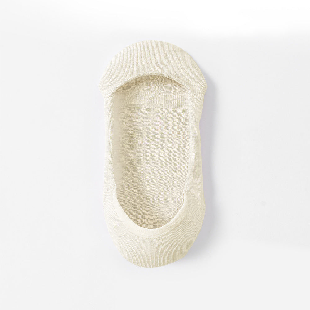 Cream-colored no-show sock liner shown from wear perspective, displaying inner lining