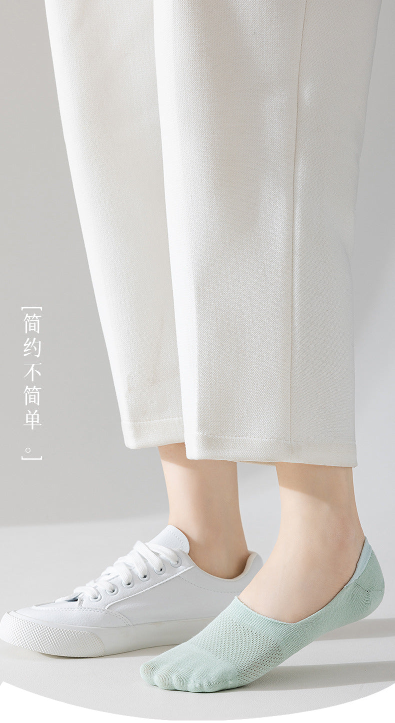 White no-show sock paired with sneaker showing low-cut design