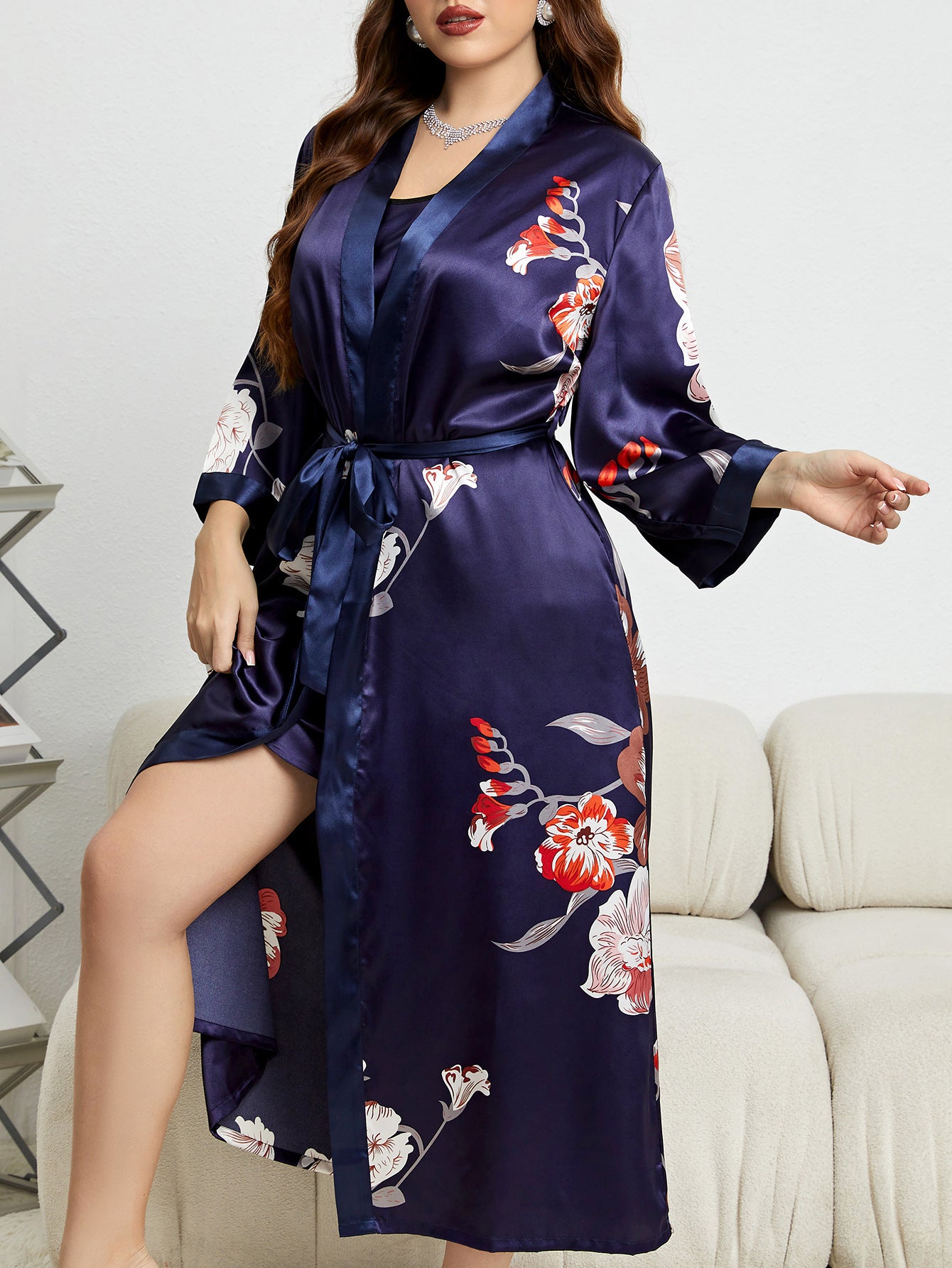 Navy blue floral satin robe with red and white flowers, side slit, worn in elegant setting