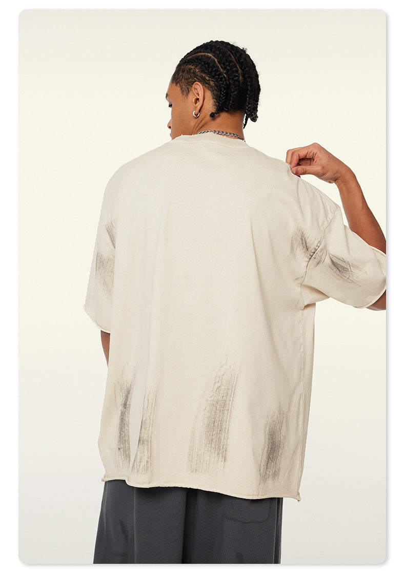 Close-up of Beattube logo on textured off-white t-shirt