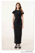 Black long denim skirt and matching short-sleeve top, with white bow-tied sneakers and oversized white sunglasses
