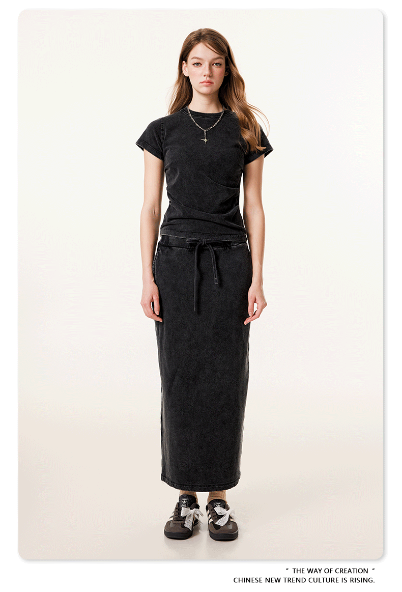 Black long denim skirt and matching short-sleeve top, with white bow-tied sneakers and oversized white sunglasses