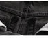 Extreme close-up of black denim twill weave texture and stitching detail
