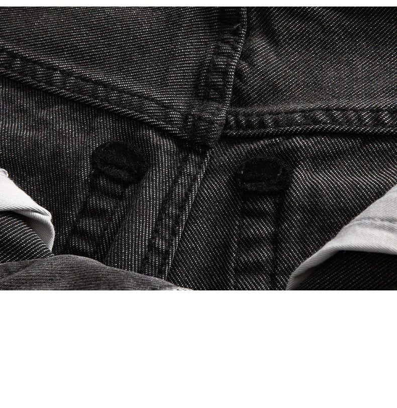 Extreme close-up of black denim twill weave texture and stitching detail
