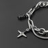 Close-up of silver chain bracelet with cross pendant and black gemstone charm on a sleek black background, showcasing intricate details.