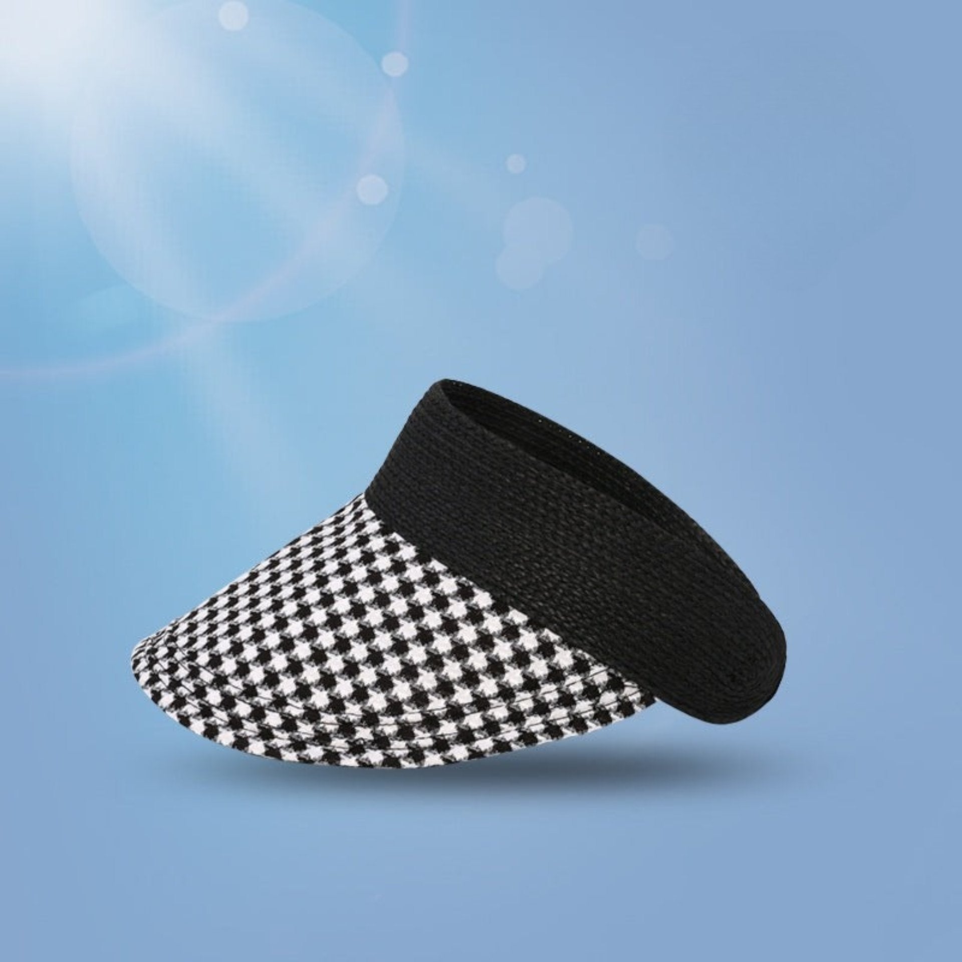 A black woven straw visor with a black and white checkered brim, featuring a UPF 50+ sun protection label in the corner.