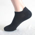 Black athletic ankle sock on mannequin foot showing cushioned sole