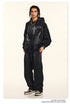 Front view black graphic hoodie and sweatpants set, accessorized with leopard print sneakers
