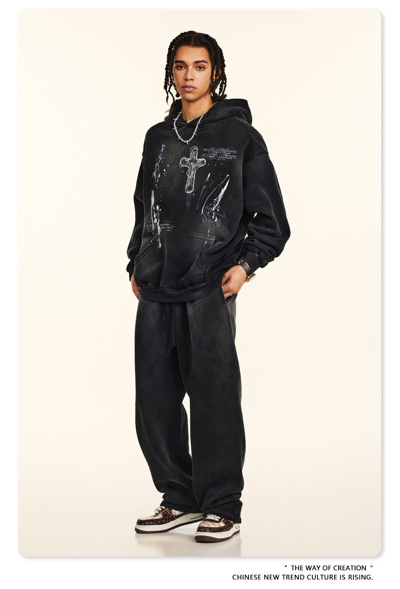 Front view black graphic hoodie and sweatpants set, accessorized with leopard print sneakers