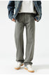 Display of wide-leg jeans in various colors from beige to purple, showcasing range of options