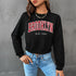 Trendy black cropped sweatshirt with Brooklyn graphic text in red, paired with light wash jeans and chain necklace