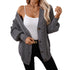 Gray cable knit cardigan with gold button closure and ribbed details, styled with white tank top and gold buckle belt