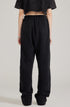 Back view of black sweatpants showing patch pockets and relaxed fit. Paired with cropped black top