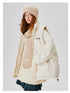 Woman in cream puffer jacket with matching knit hat and scarf, partially unzipped to show layering against white background