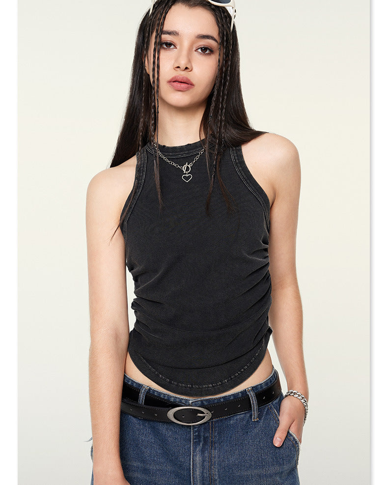 Black sleeveless top showing side gathering detail