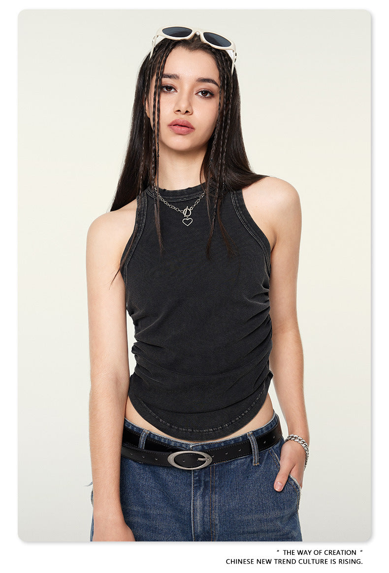 Black sleeveless top showing side gathering detail